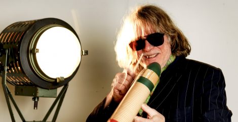 Künstler Helge Schneider mit Sonnenbrille neben einem Scheinwerfer